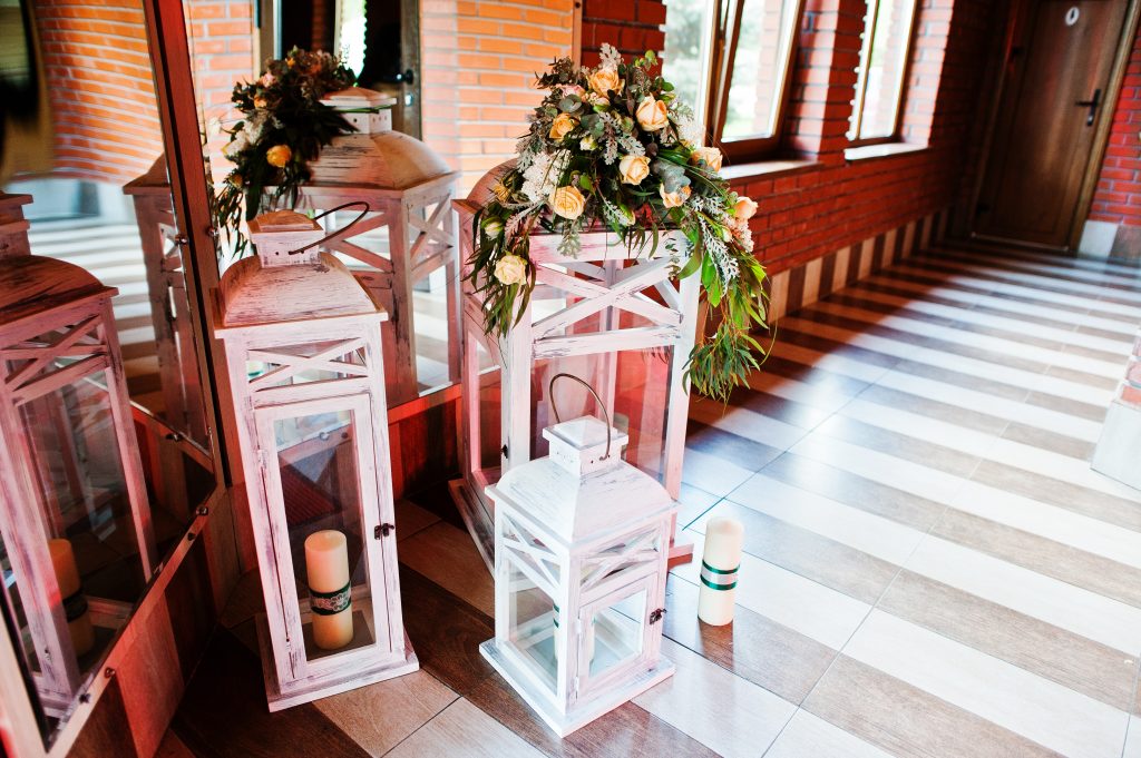 Elegance wedding reception decor. Vintage wooden candlesticks with candles